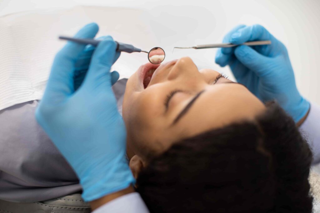 Dental hygienist performing professional cleaning on a patient in Orlando