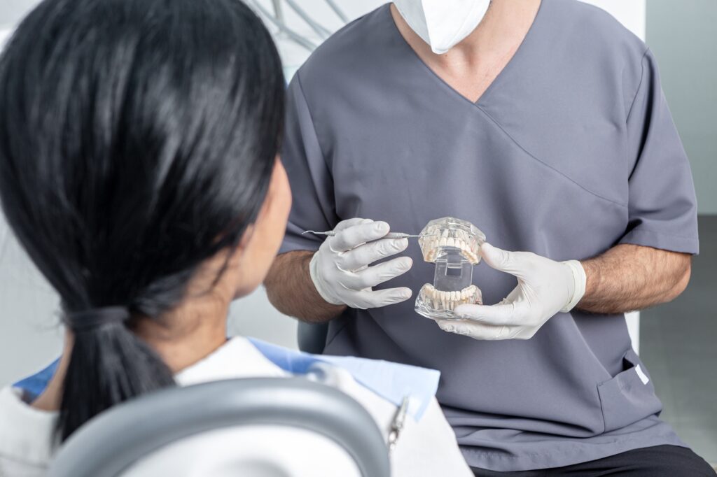 Dentist in Orlando showing a patient a dental crown option at Crescent Dental