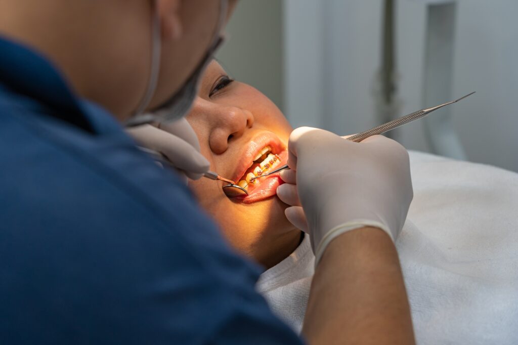 Dentist examining a patient with bleeding gums at Crescent Dental in Orlando