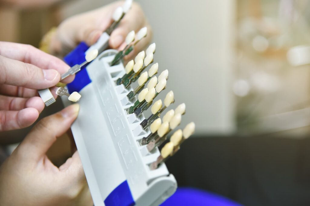 Dentist comparing dental crowns and veneers with an Orlando patient